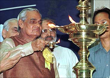 Ex-Indian Prime Minister Atal Behari Vajpayee (L) lights a lamp at an Ayurvedic conference.
