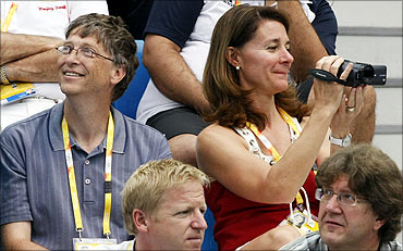 Microsoft chairman Bill Gates and wife Melinda watch the swimming finals during the Beijing Olympic Games.