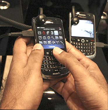 A man tests a BlackBerry phone at a shopping mall.