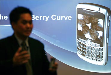 Norm Lee, vice president of Research in Motion, poses with the new Blackberry Curve 8300 phone.