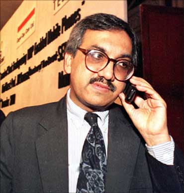 Ravi Narain chairman of the National Stock Exchange speaks on his mobile phone at a function to launch the first WAP-enabled share transaction in India, in Bombay on December 14, 2000.