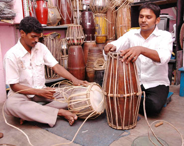 P Muthulingam repairing percussion instruments at his workshop.