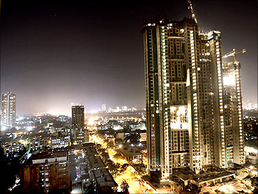 A high-rise building is lit up during construction in Mumbai.