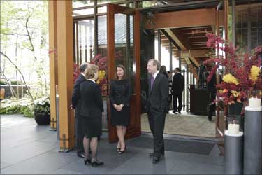 Washington Governor Chris Gregoire (2nd L) and her husband Mike Gregoire (L) talk to Melinda Gates (C) at the entrance of the house.