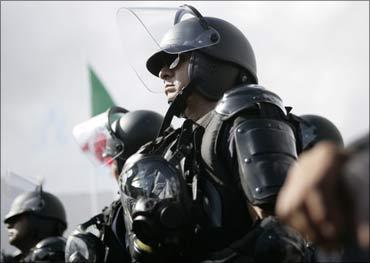 Police wearing anti-riot gear stand in formation near the venue of the climate talks in Cancun. Photograph: Gerardo Garcia/Reuters