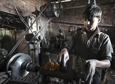Mubin, 13, works in an aluminium factory in Dhaka.