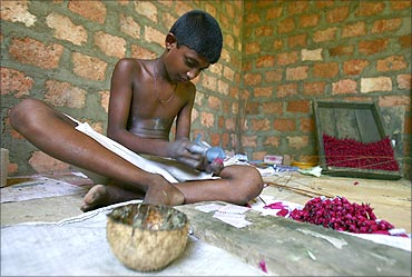 A boy makes bottle rockets at a fireworks factory near Galle, south of Colombo.