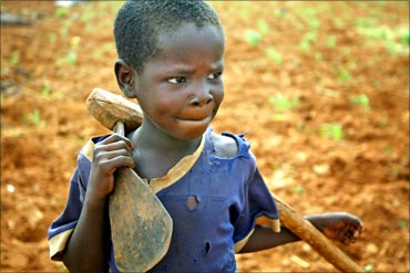 A young boy takes a break from tilling a field in southern Niger.