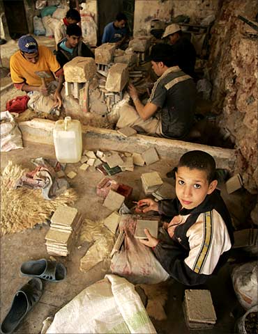 Children work at a stone workshop near Kenitra, Morocco.