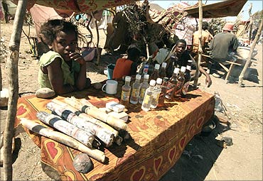 A girl sells beer and food for miners at the Bepeha sapphire mine, Madagascar.