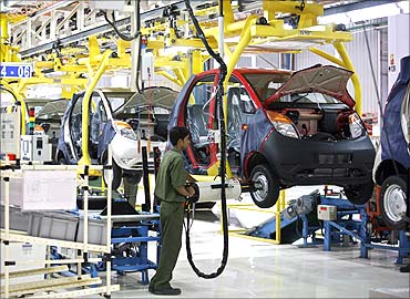 An employee works inside the newly inaugurated plant for the Tata Nano car at Sanand.