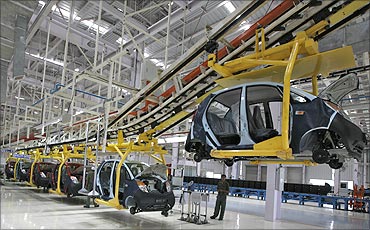 An employee stands inside the newly inaugurated plant for the Tata Nano.