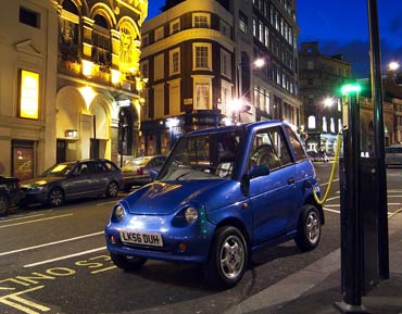 A Reva getting charged on a London street.