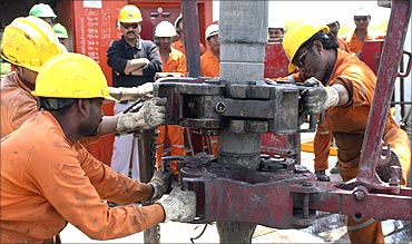 Engineers of Oil and Natural Gas Corp (ONGC) work inside the Kalol oil field.