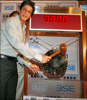Bollywood actor Shah Rukh Khan poses before hitting the ceremonial gong during his visit to the BSE.