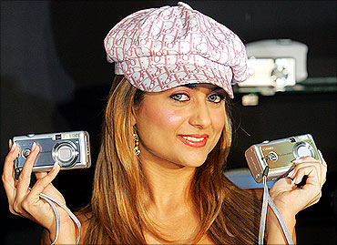 Bollywood actress Amrita Arora poses with Canon 'Powershot A400' digital cameras.