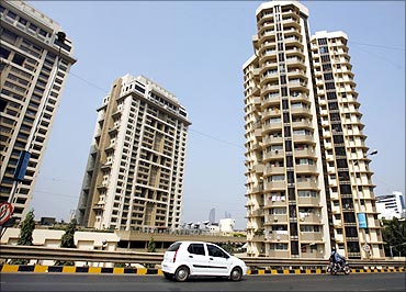 A vehicle drives past residential buildings in India's financial capital Mumbai.