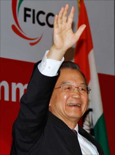 Chinese Premier Wen Jiabao waves as he attends the India-China Business Cooperation Summit in New Delhi on December 15, 2010.