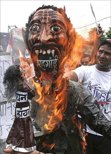 Activists of Samajwadi Party burn an effigy of Inflation.
