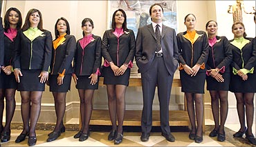 Jeh Wadia, Managing Director of GoAir with flight attendants.