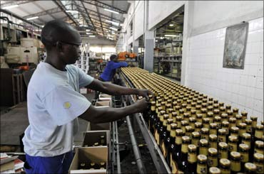 Workers package beer at Cervejas de Mocambique, a subsidiary of giant SAB Miller, in Maputo, Mozambique.