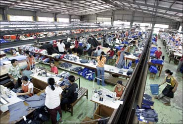 Factory workers assemble garments to be exported abroad on the outskirts of the Laotian capital Vientiane.
