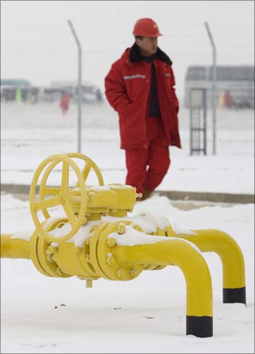 A worker walks past gas taps of the Kazakh stretch of the new 1,833-kilometre Turkmenistan-China pipeline at Otar gas station, near Almaty.