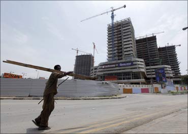 An Angolan man walks past office blocks under construction in the capital Luanda.