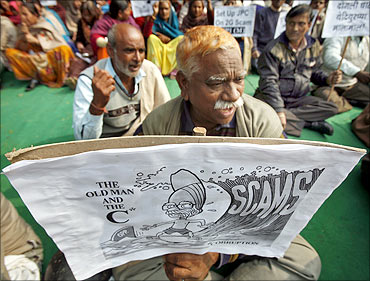 Activists of Communist Party of India Marxist CPI (M) hold a cartoon placard.