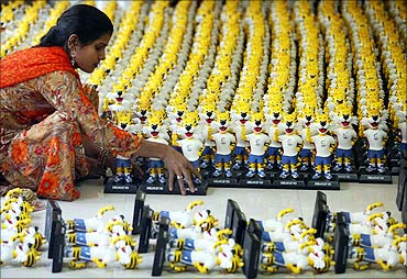 A worker arranges models of the mascot of the Commonwealth Games before packing them.