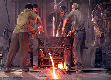 Labourers work inside a steel factory in Siliguri.