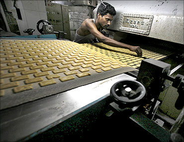 A worker sorts out damaged biscuits at a factory in Kolkata.