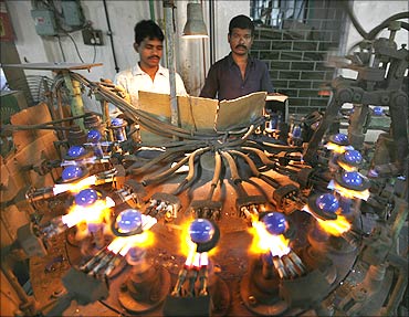 Indian labourers work in a bulb factory in Kolkata.