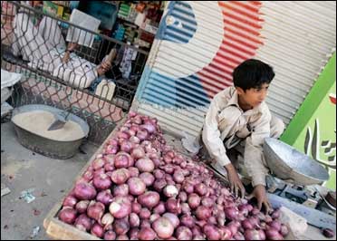 A boy sells onions in Karachi.
