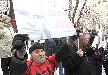 People hold portraits of Mikhail Khodorkovsky during a rally in support of Khodorkovsky.
