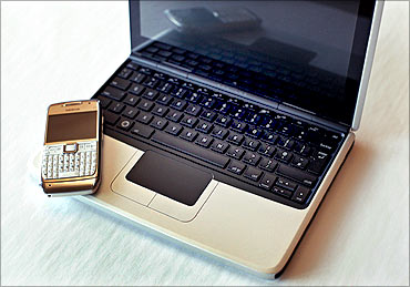 Nokia's new netbook computer, the Booklet 3G, is seen next to a Nokia handset at corporate headquarters in Helsinki.