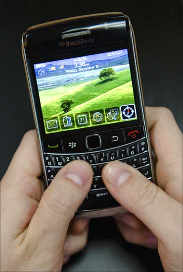 A person poses while using a Blackberry Bold 2 smartphone at the Research in Motion headquarters in Waterloo.