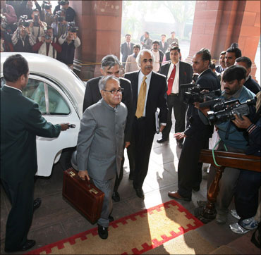 Finance Minister Pranab Mukherjee arrives at Parliament to unveil last year's Budget.