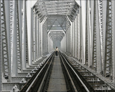 A man crosses a railway bridge on Teesta River near Siliguri.