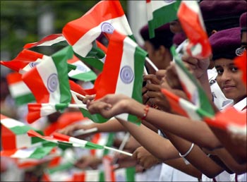 Image: Schoolchildren waving the Indian flag. Photograph: Reuters