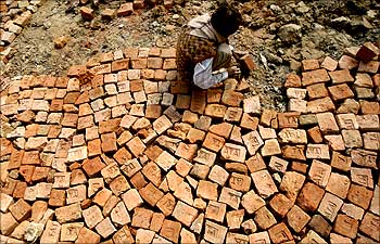 A labourer works at a road construction site in Bihar.