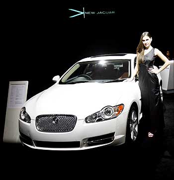 A model poses with a Jaguar XF at India's Auto Expo in New Delhi.