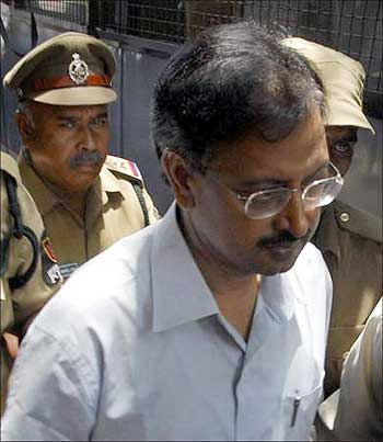 B Ramalinga Raju is escorted from a court in Hyderabad.