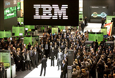 Employees at the booth of IBM at CeBIT computer fair in Hanover.