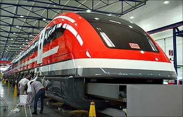 Workers polish a prototype of the new maglev Transrapid high-speed train in the central German city of Kassel.