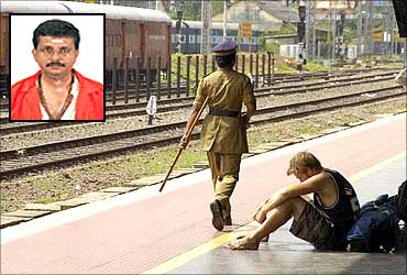 A tourist sits on an empty railway platform in Palakkad.