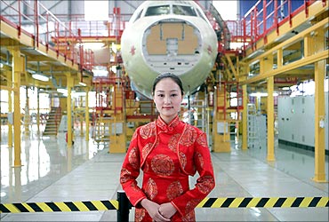 A staff member stands in front of the new Airbus A320 assembly line at its plant in Tianjin.