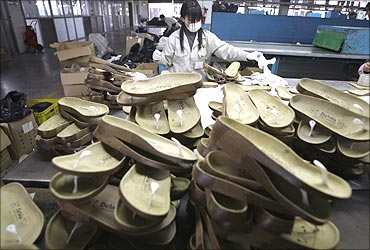 A woman works at a shoe factory in Dongguan, southern China's Guangdong province.