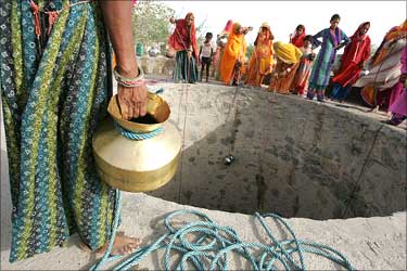 Women drawing water from the well.