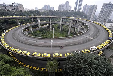Taxis line up to get their tanks filled on a ramp in Chongqing municipality